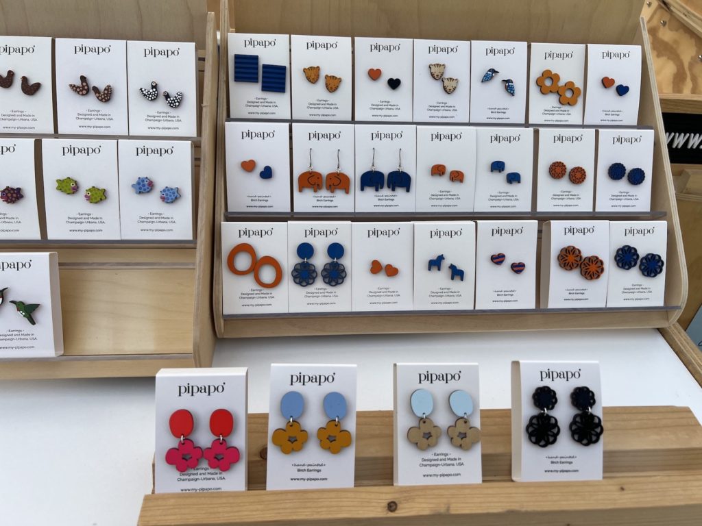 colorful earrings on white cards are displayed