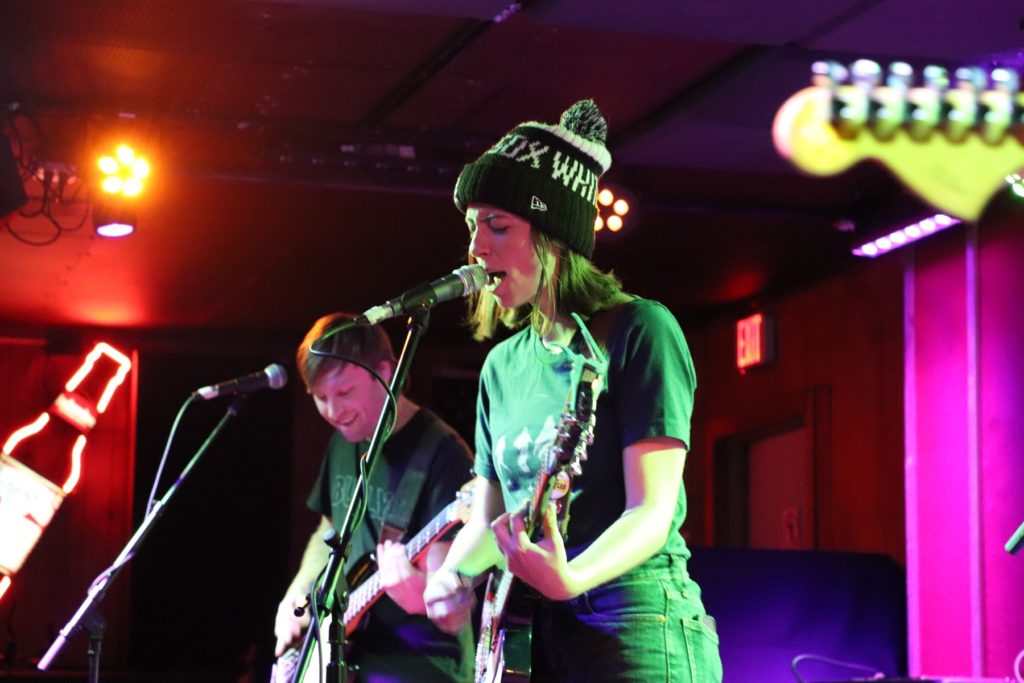 Ratboys' lead singer playing guitar wearing a white sox beanie
