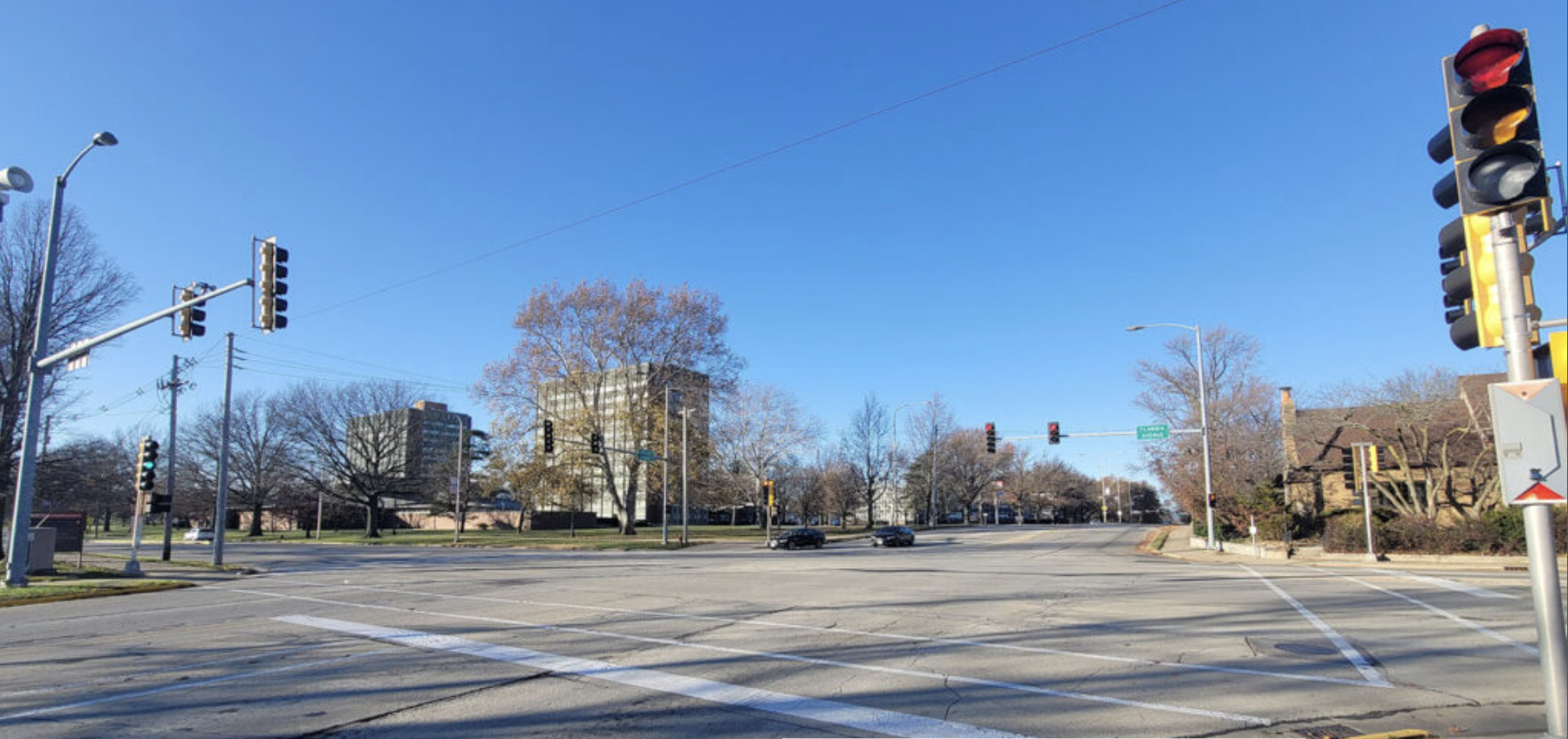 Intersection of Lincoln and Illinois in Urbana. The intersection is mostly empty. Only two cars are pictured across the intersection from the photographer.