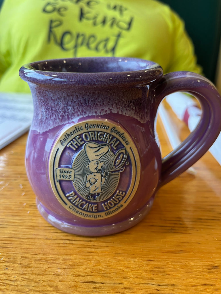 Beautiful purple coffee cup with the restaurant's logo.