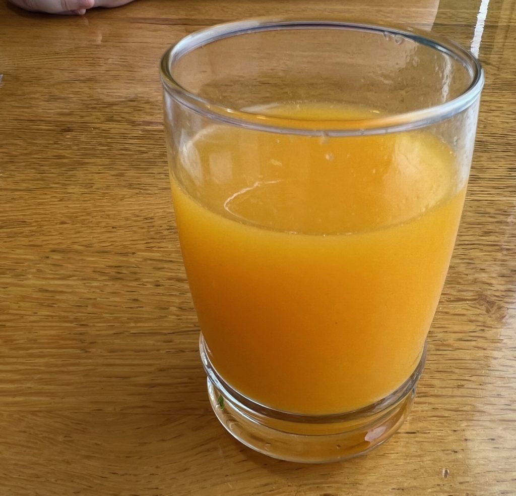 A small cup of freshly-squeezed orange juice