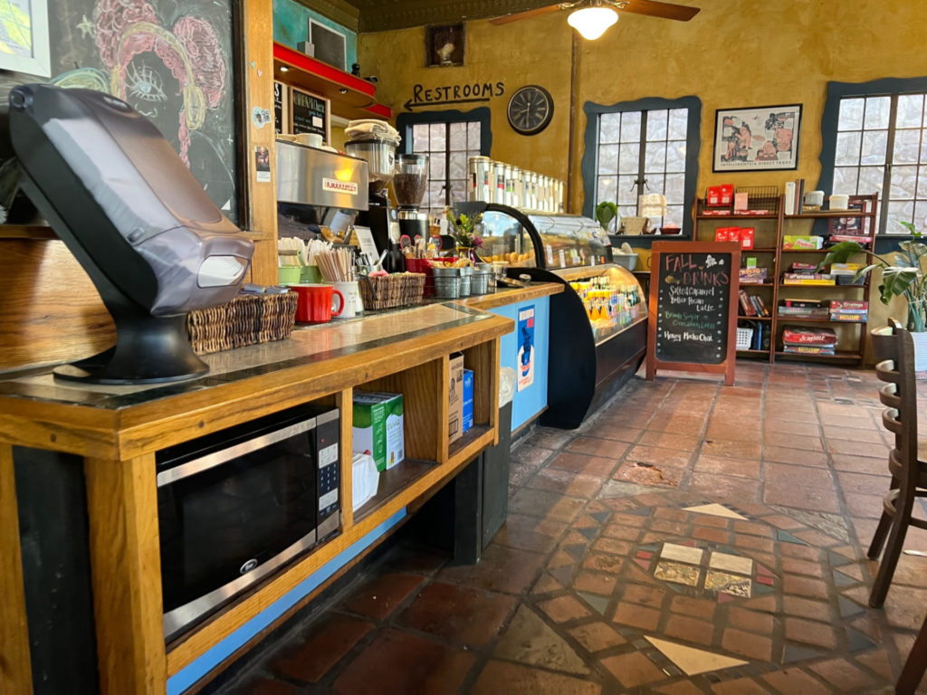 Inside Caffe Paradiso, there is no line to order and there is a self service station with napkins, utensils, wooden stirring sticks, and a microwave.