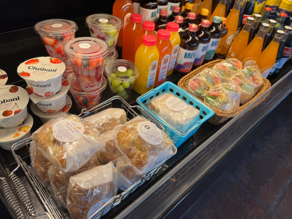 Inside Caffe Paradiso, the cold case has a selection of yogurt, fruit, juices, soda, and cold sandwiches wrapped in plastic.