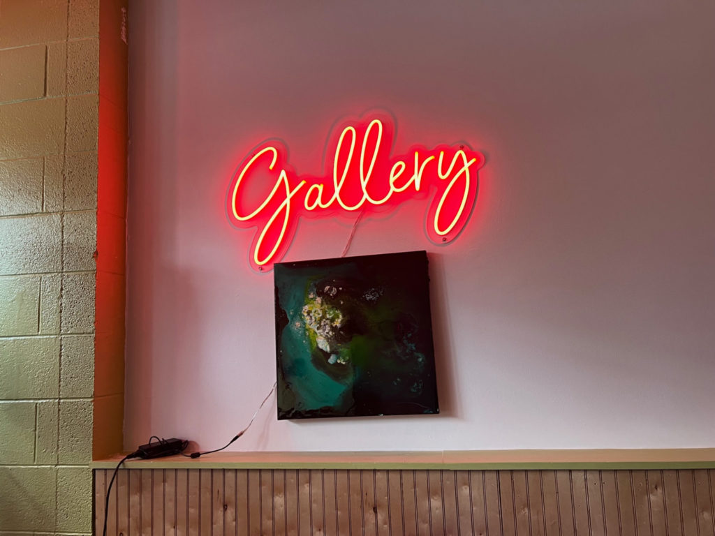 An illuminated red sign reading "Gallery" inside Gallery Art Bar in Downtown Urbana. 