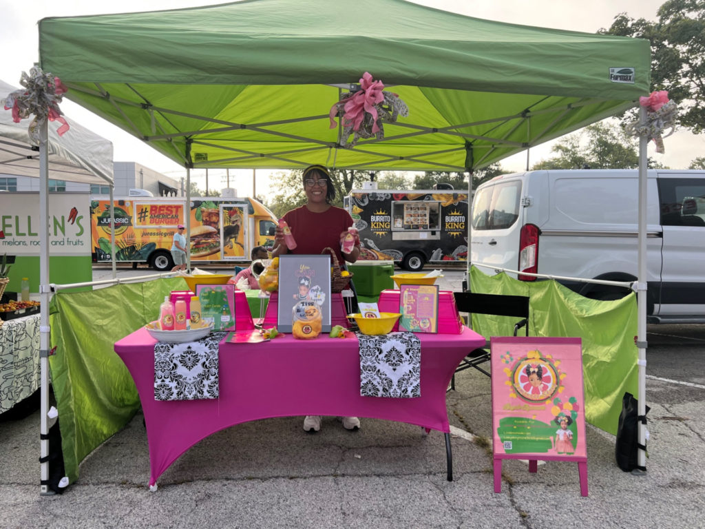 At the Urbana Market at the Square, the owner of Leeyah-Symone's Lemonade Stand sells pink lemonade at the Urbana farmers' market.