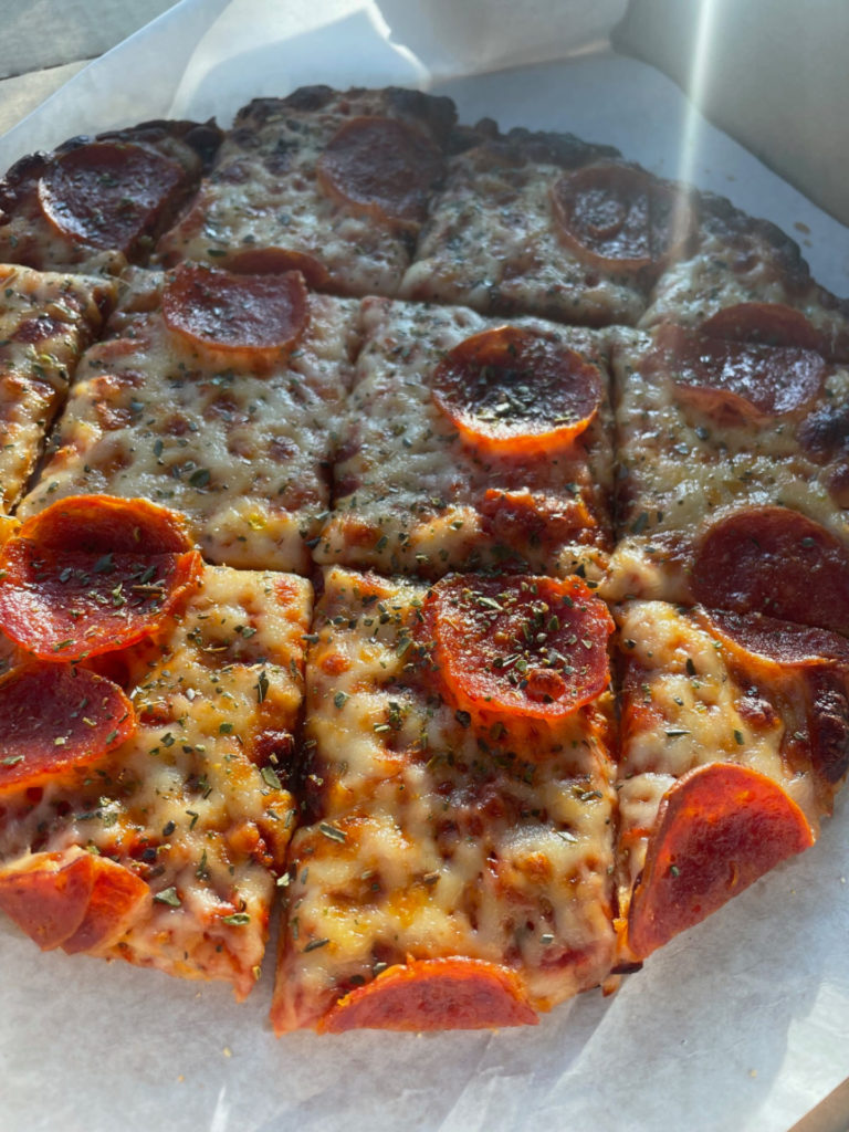 A close-up photo of a square-cut pepperoni pizza from Jupiter's.