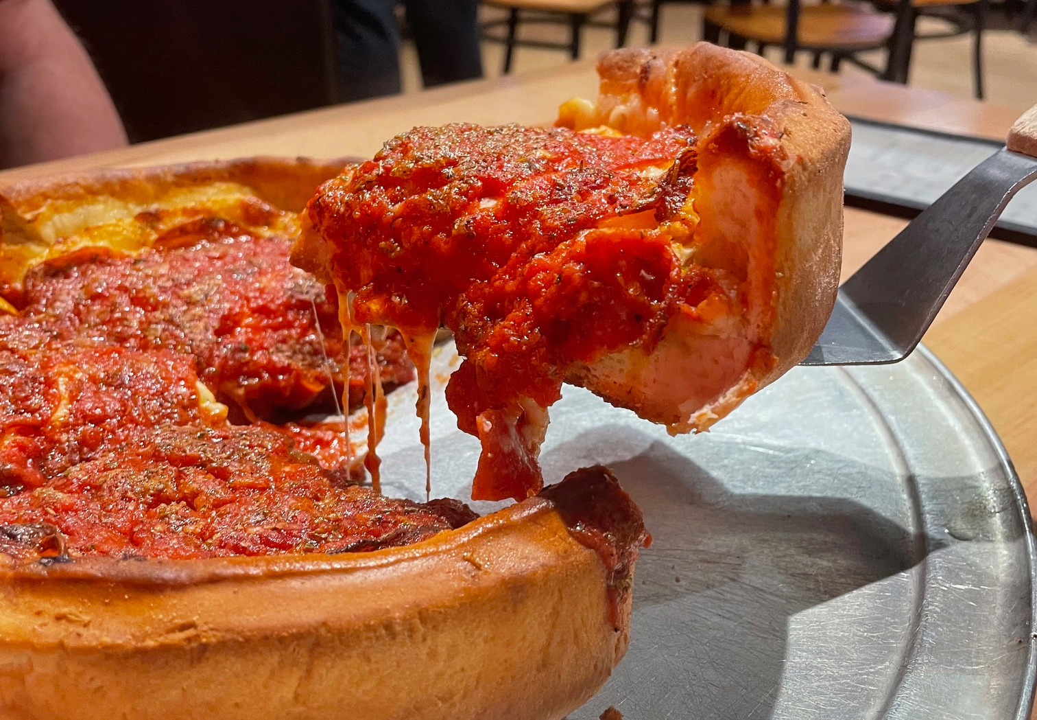 A thick slice of Chicago-style deep-dish pizza at Papa Del's in Champaign.