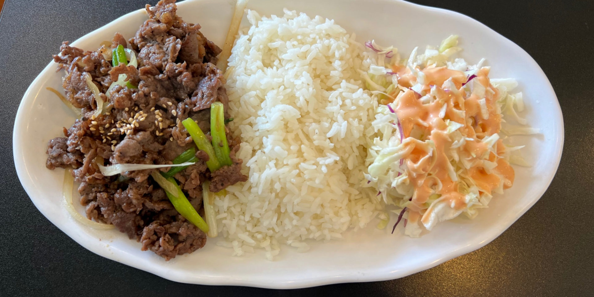 Beef bulgogi lunch special with white rice and a simple cabbage salad from San Maru in Champaign.