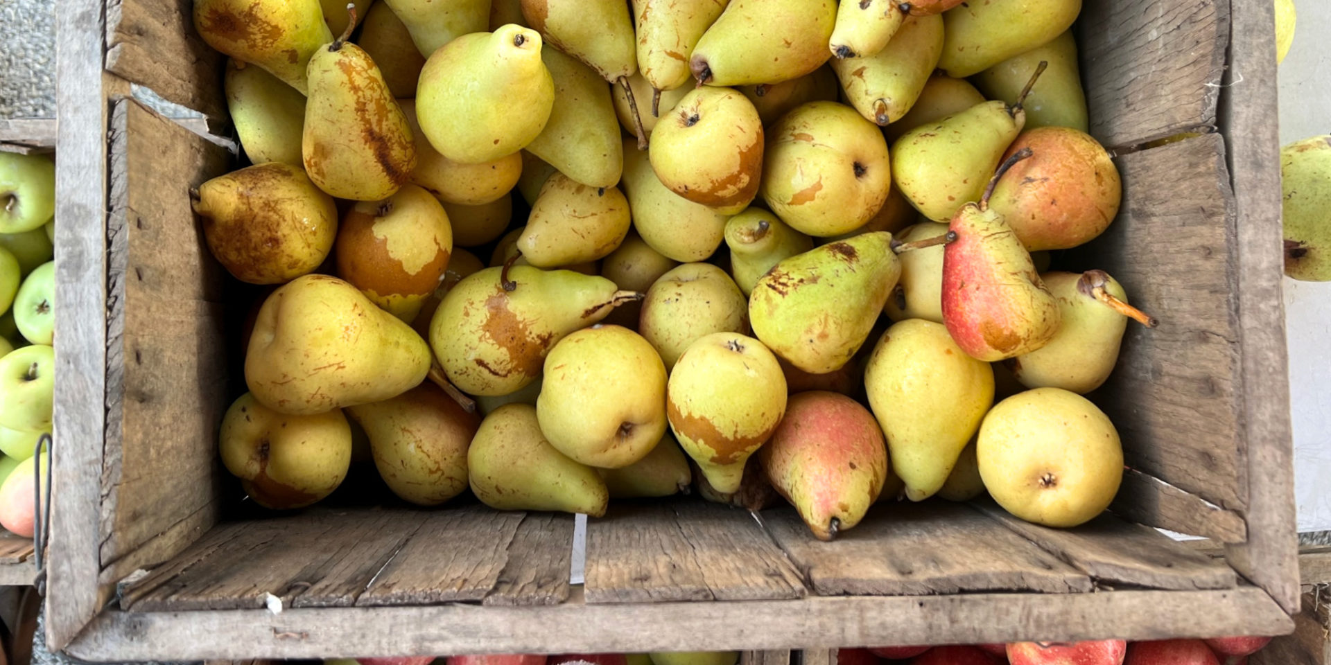 A brown wooden box of pears for sale at the C-U farmers' market