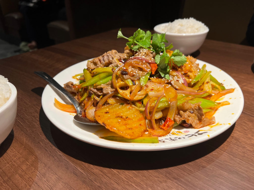 A plate of veggies with spicy beef.