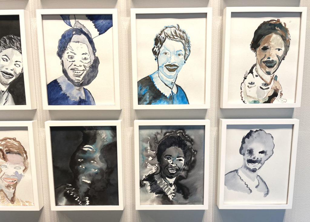 Detail: eight ink on paper drawings / paintings of the same woman. They are 11 x 14 inches in white frames, all framed individually. Each image is different and some have color.