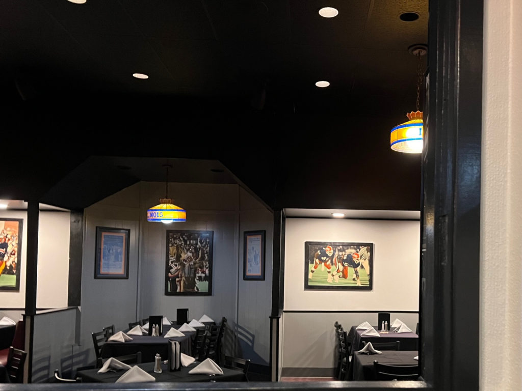 Inside the restaurant hang Illinois light fixtures and framed photos of Illini athletes.