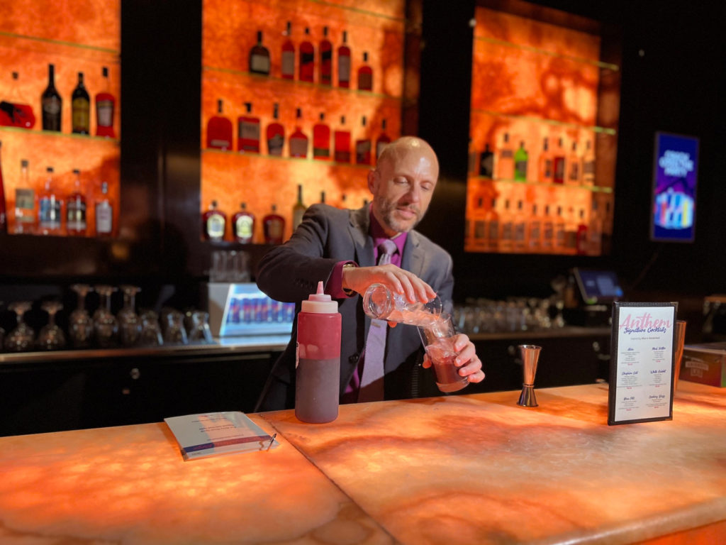 Michael Maggi mixes a drink from the menu he made.