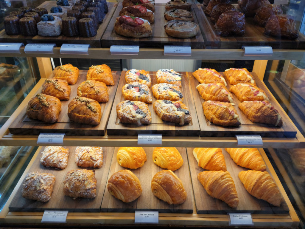 Various croissants and pastries ranging from $4.25 for a butter croissant to $6.15 for a specialty croissant.