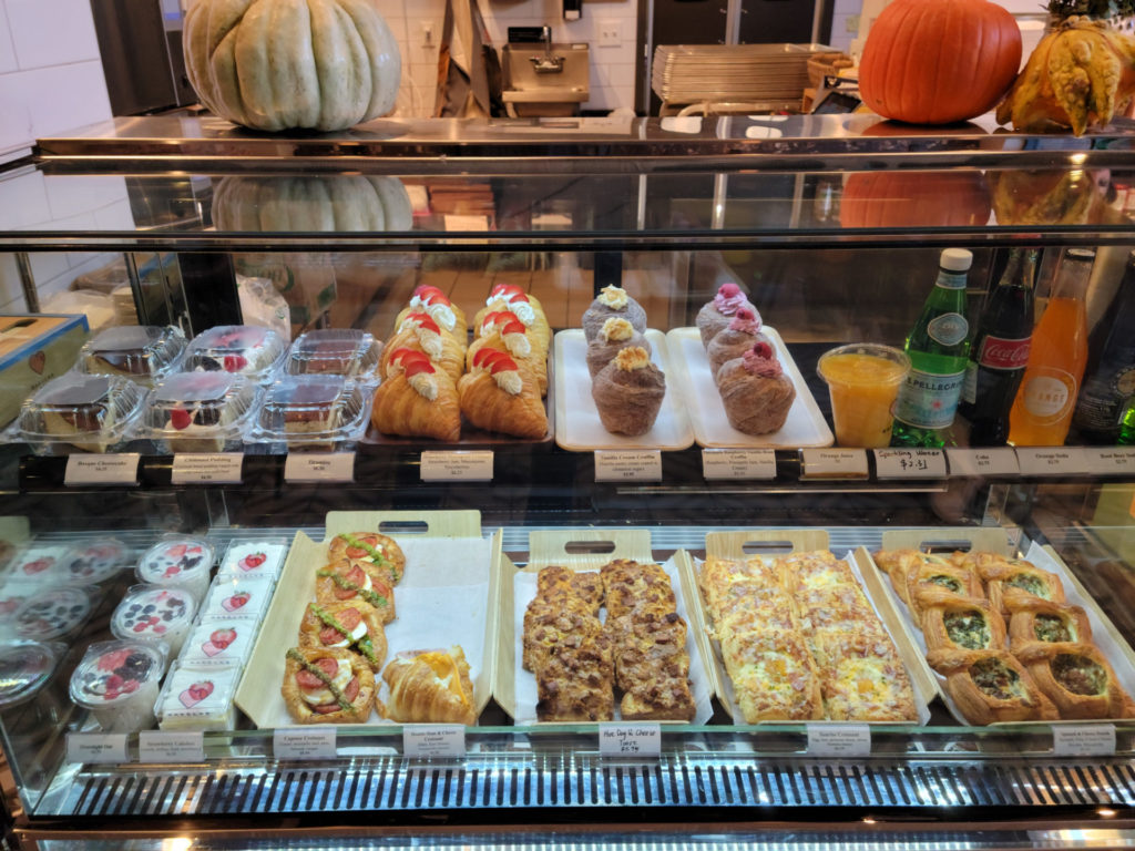 Pastries, drinks, and cakes ranging from $2 for orange juice to $6.95 for a double ham and cheese croissant.
