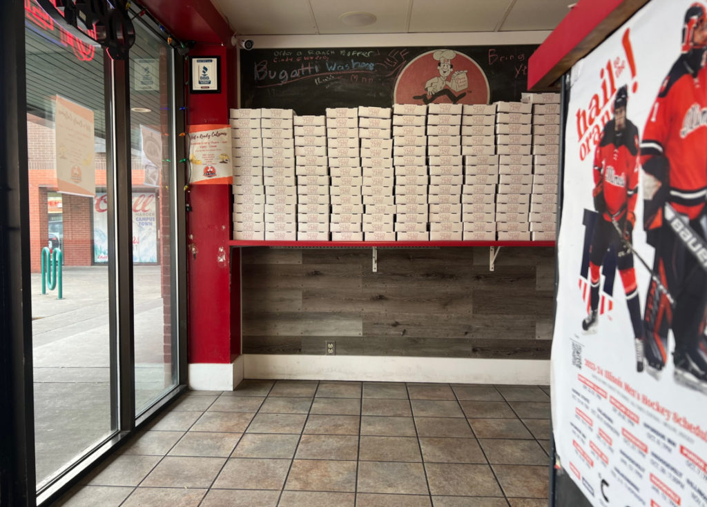 Inside of DP Dough there are boxes lined up ont he wall.