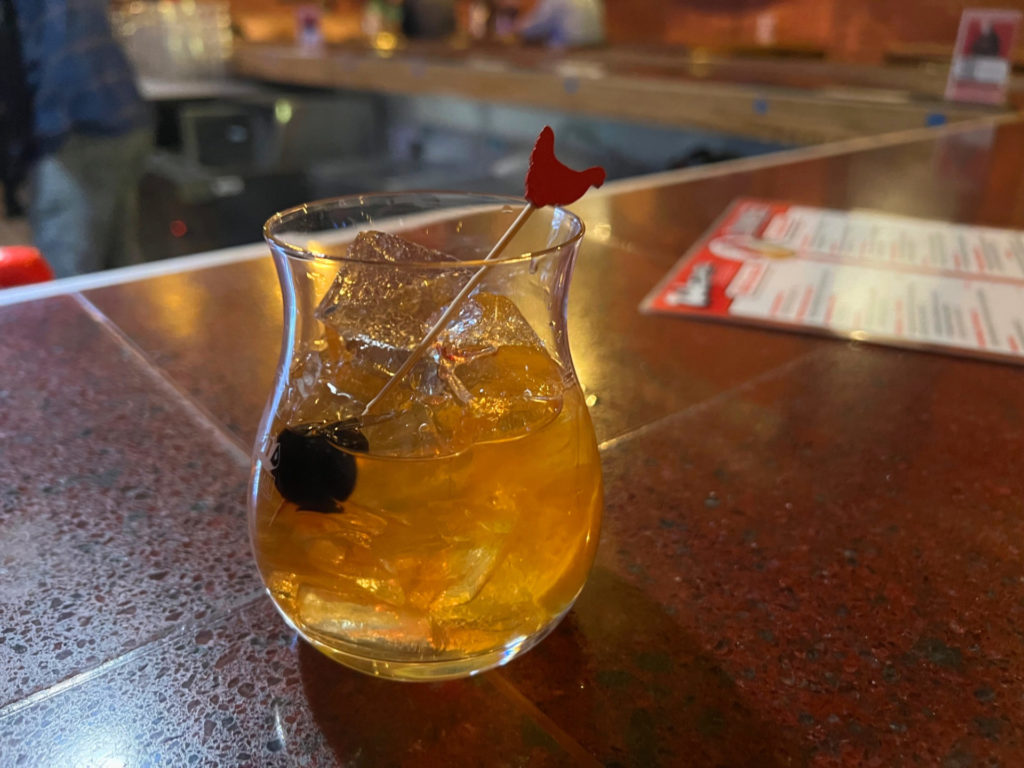 An old fashioned at Watson's Shack & Rail has a rooster toothpick spearing a cherry.