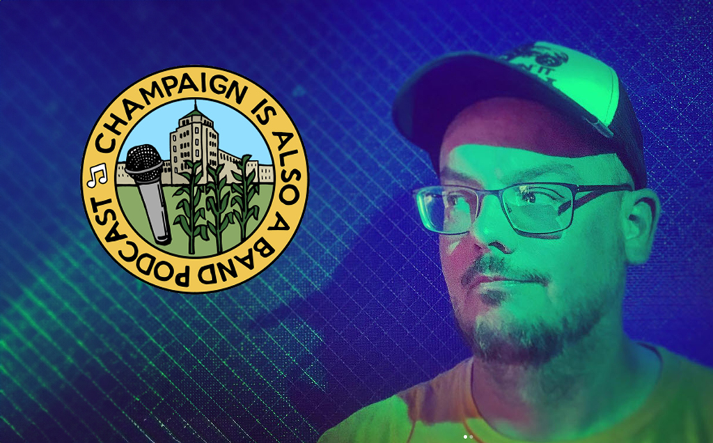A man is on the right side of the image, looking towards the left side. He's got a baseball hat on, with glasses and a yellow t-shirt. On the left side of the photo is the logo for "Champaign is Also a Band Podcast"