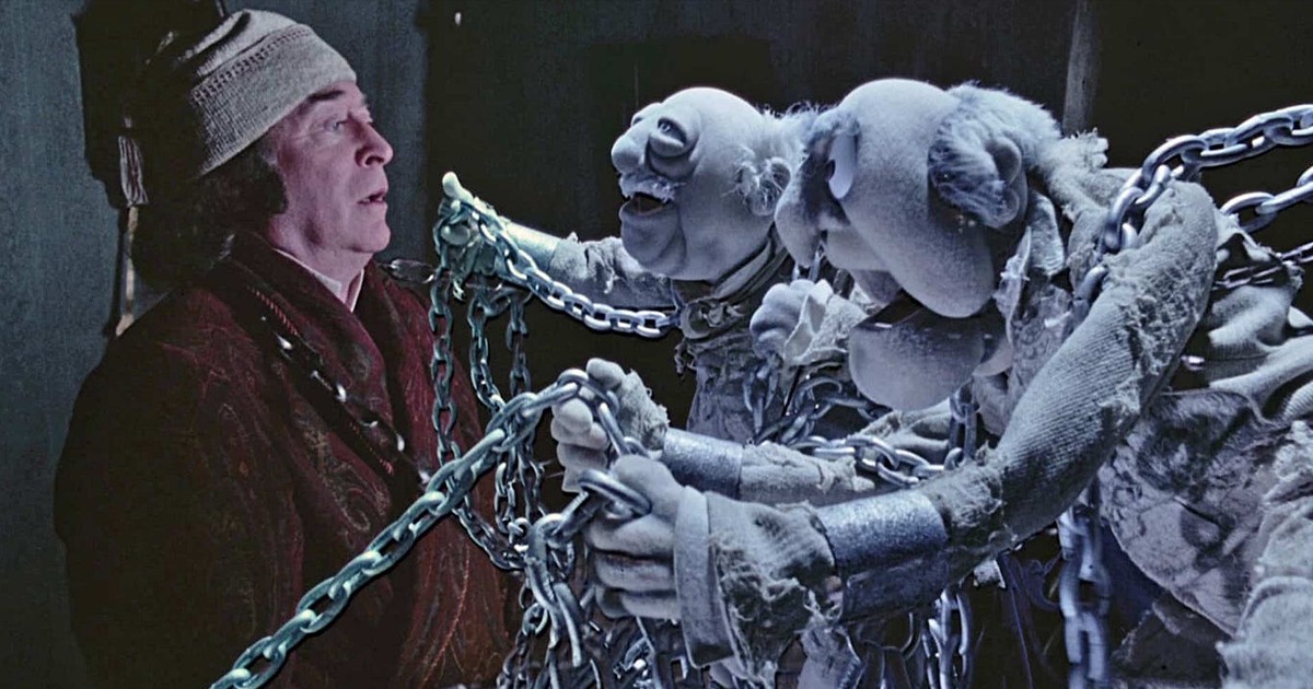 A scene from Muppet Christmas Carol, with Muppet ghosts pushing Jacob Marley against a wall.