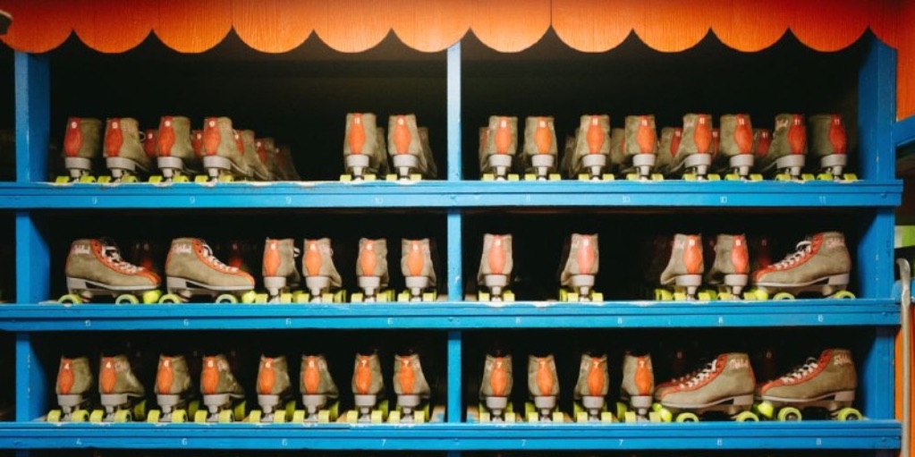 Rollerskates are lined up on blue and orange shelves at Skateland in Savoy.