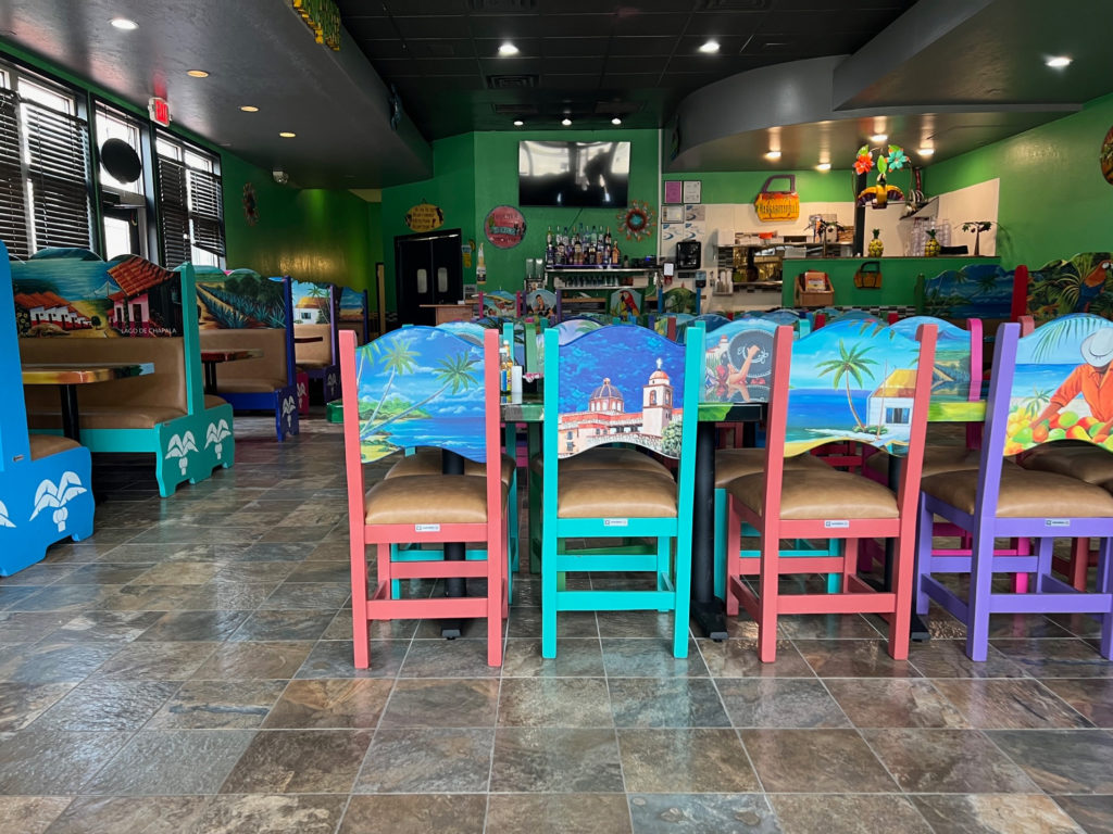 Inside Casa Margaritas in Champaign, there are brightly colored booths and high back chairs.