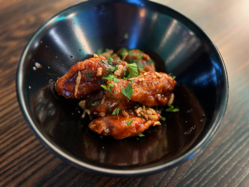 An order of six honey bourbon chicken wings at The Space restaurant in Downtown Champaign.