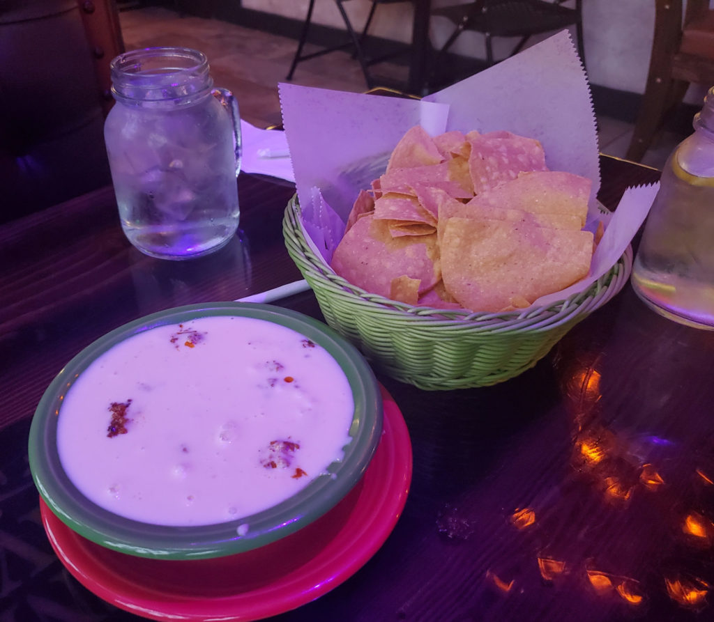 Queso fundito with a basket of chips.