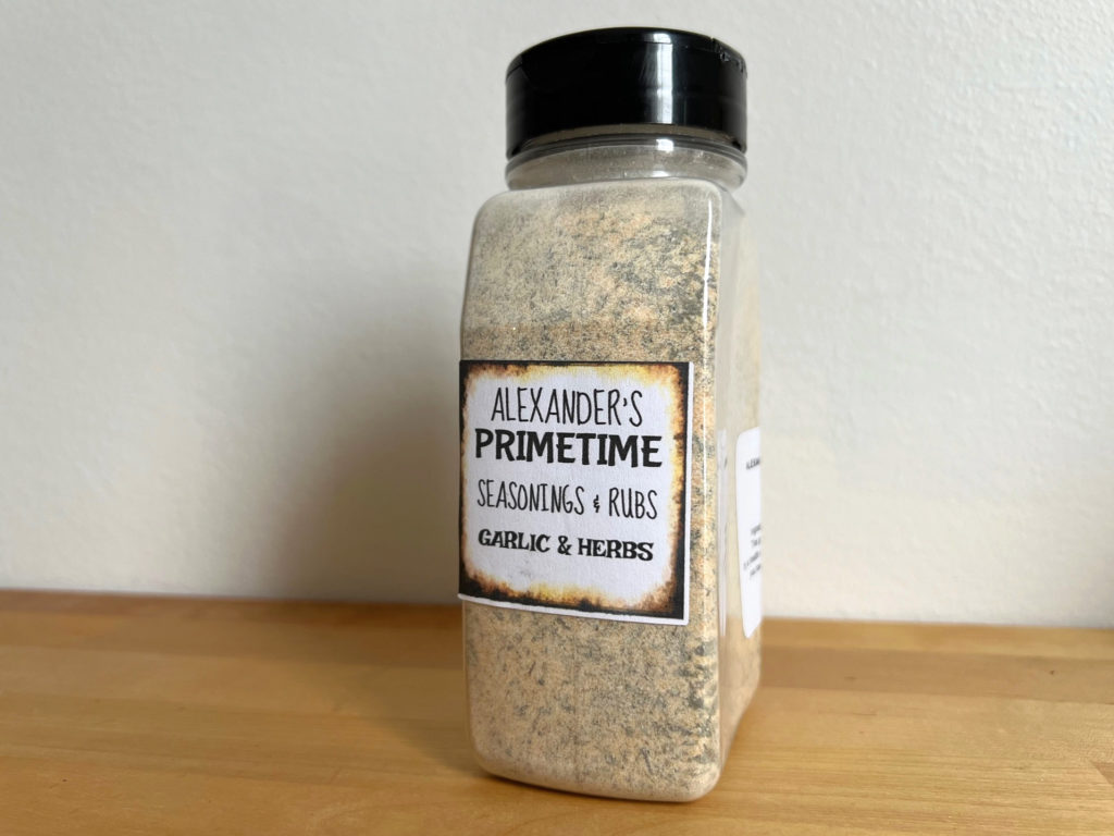 A spice container with Alexander's Primetime Seasonings & Rubs in the flavor garlic & herbs.