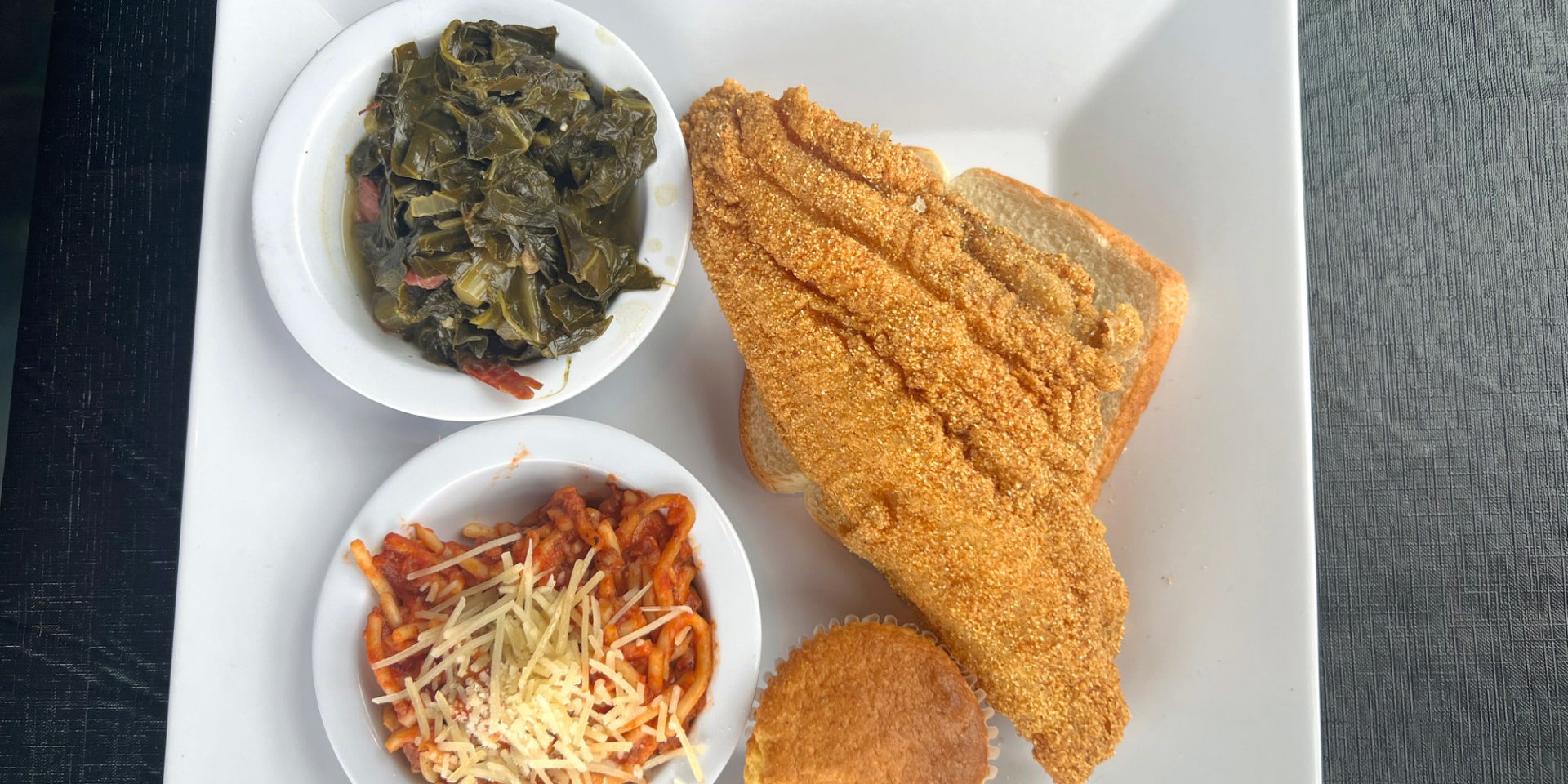 An order of fried catfish, cornbread, and sides of spaghetti and collared greens at Neil St Blues restaurant in Downtown Champaign.