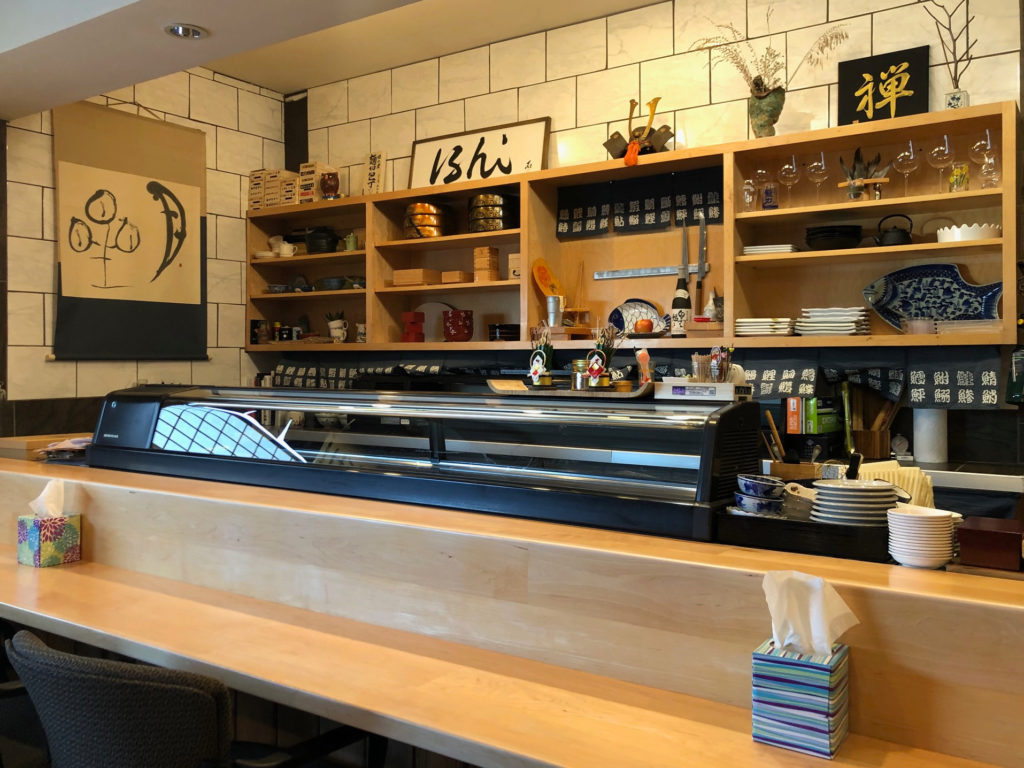 The interior of ISHI restaurant has a sushi bar.