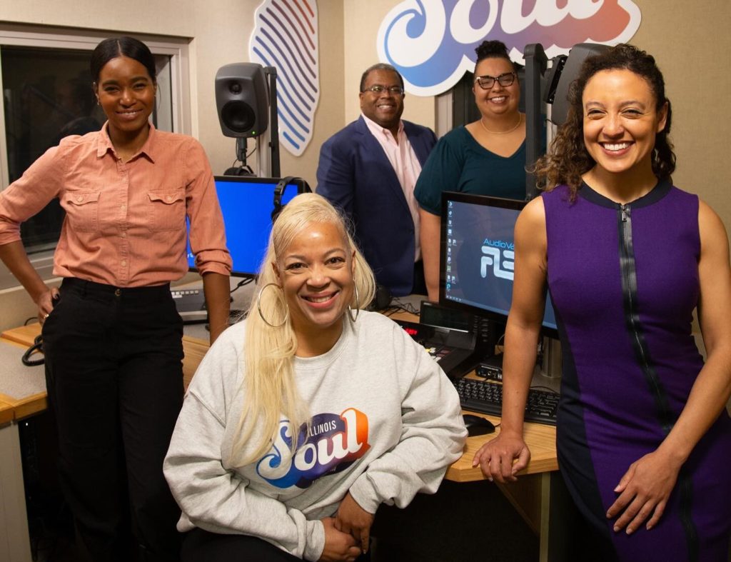 Three Black women and one Black man are gathered in the Illinois Soul studio, posed for a photo.