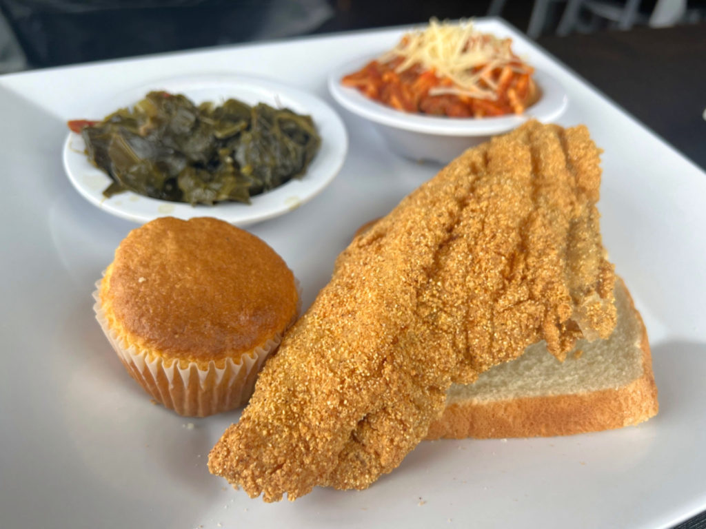 An order of fried catfish, cornbread, and sides of spaghetti and collared greens at Neil St Blues in Downtown Champaign.