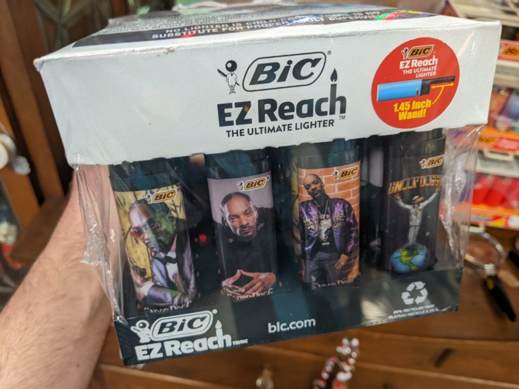A box of BIC lighters each with a different picture of Snoop Dog on them. 