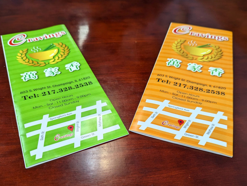 Two menus one green and one orange for Cravings restaurant.