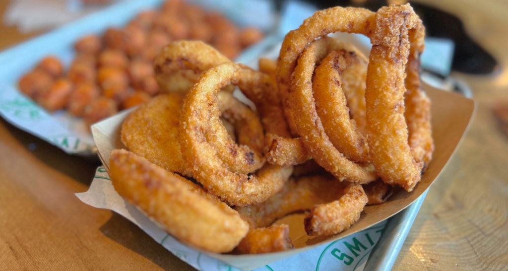 An order of onion rings at Smith Burger Co inside Collective Pour bar in Champaign, Illinois.