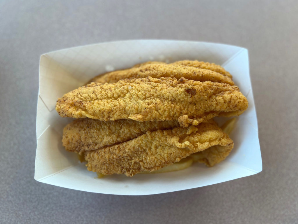 Two catfish over fries at Wood N' Hog restaurant in Urbana, Illinois.