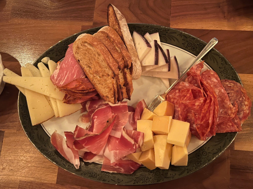 A platter of cheese, meats, and sliced baguette at Bakery & Pickle.