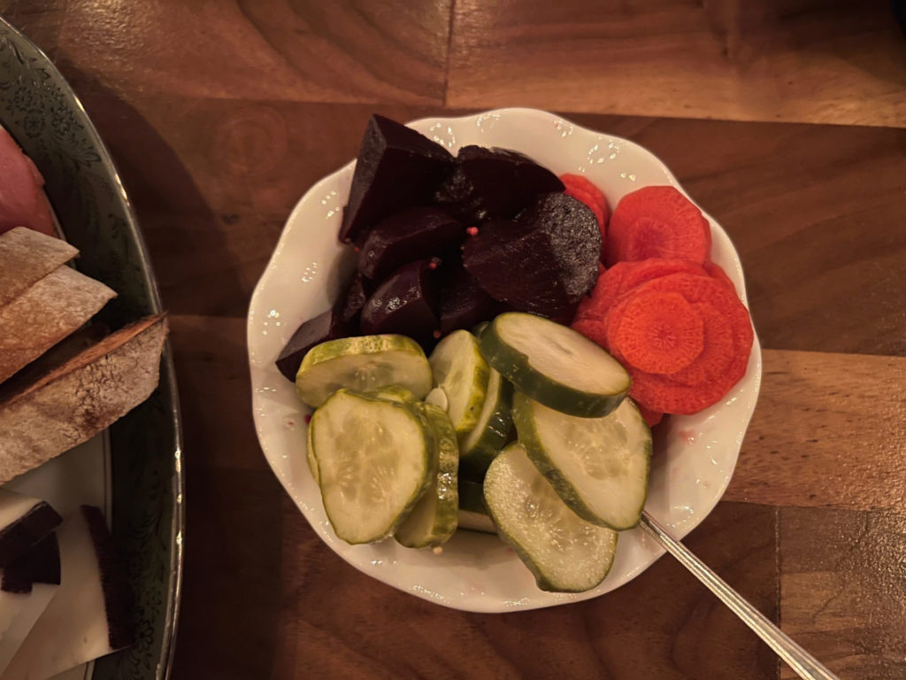 A white bowl of beets, carrots, and cucumber pickled in house at at Bakery & Pickle.