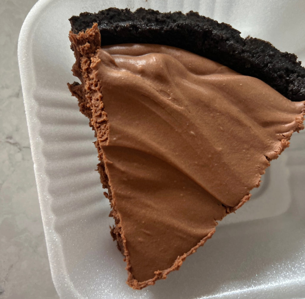A slice of Po' Boys double chocolate pie in a to go container.