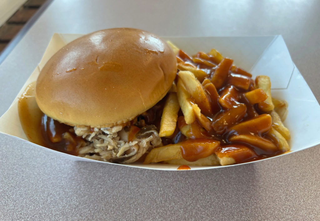 Wood N Hog restaurant has pulled chicken with fries and sauce.