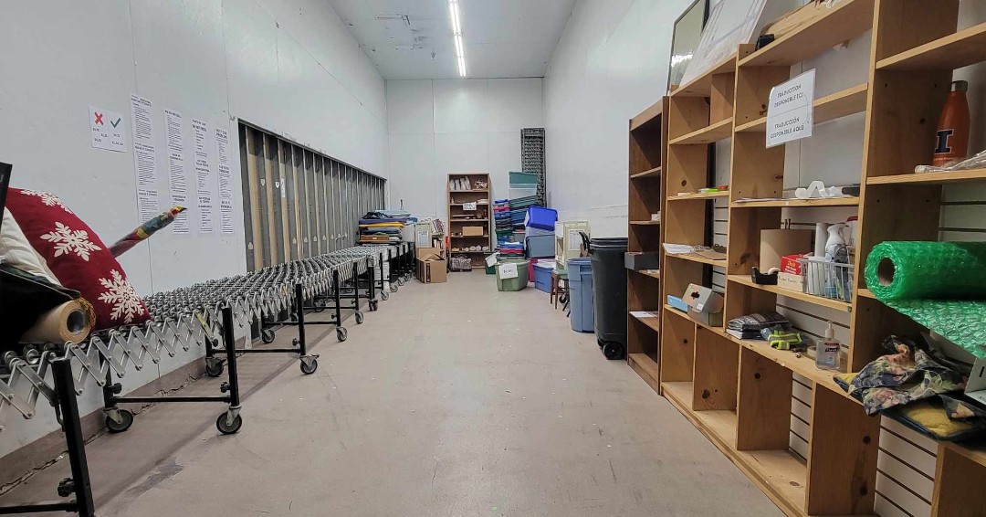 A large room with shelving along one wall.