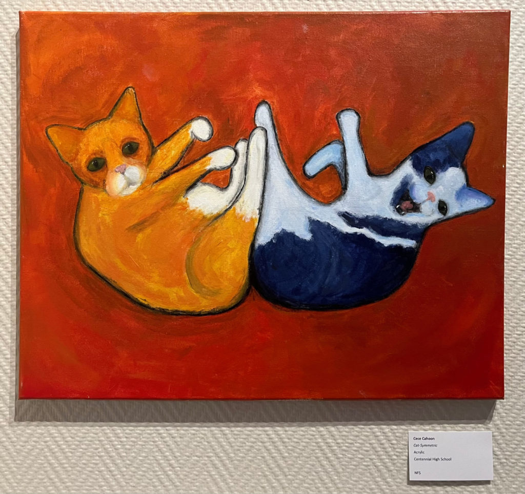 Painting of a bright orange background with an orange and white tabby cat and gray-blue and white tabby cat playing.