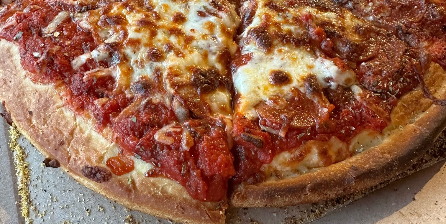 A close up of pepperoni pizza by Garcia's Pizza in a Pan restaurant of Champaign.