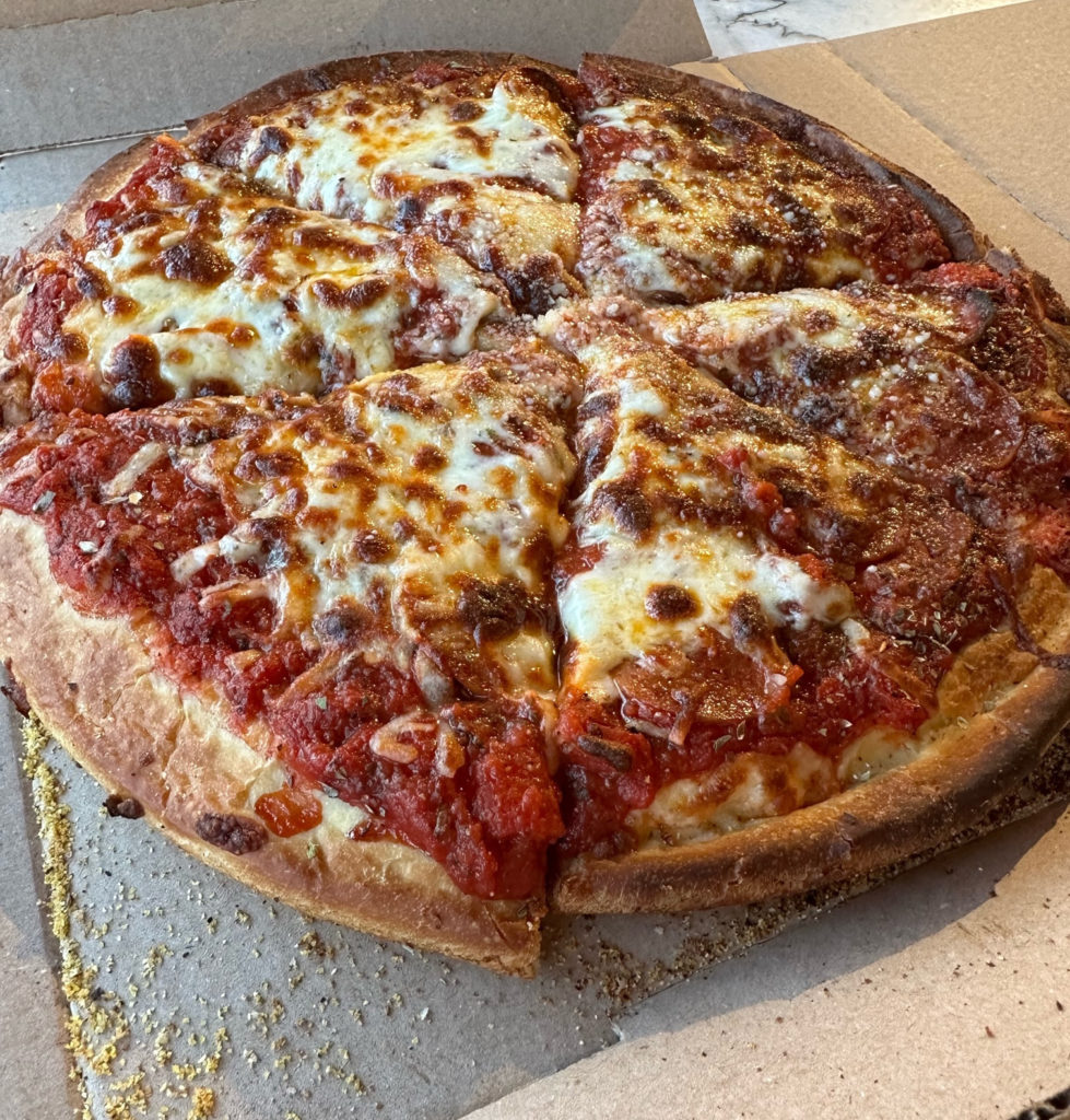 A sliced full pizza pie in a cardboard box from Garcia's Pizza of Champaign.