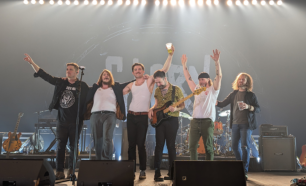 6 members of The Glorious Sons taking a bow onstage after a performance.