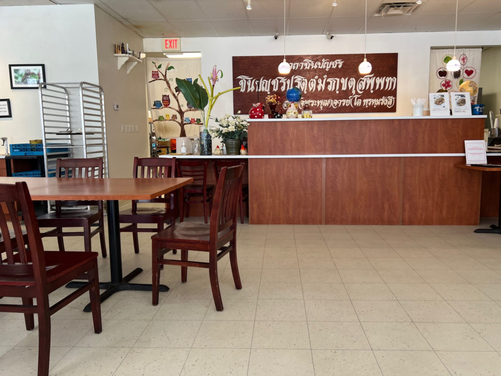 The interior of Basil Thai restaurant has brown chairs and a brown ordering counter.
