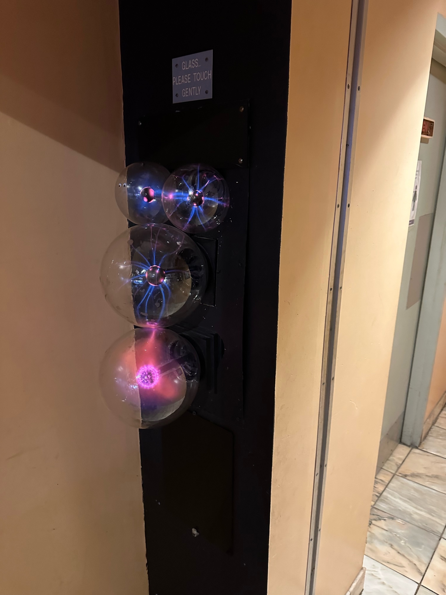 Four clear globes with lightning on display at a local restaurant.