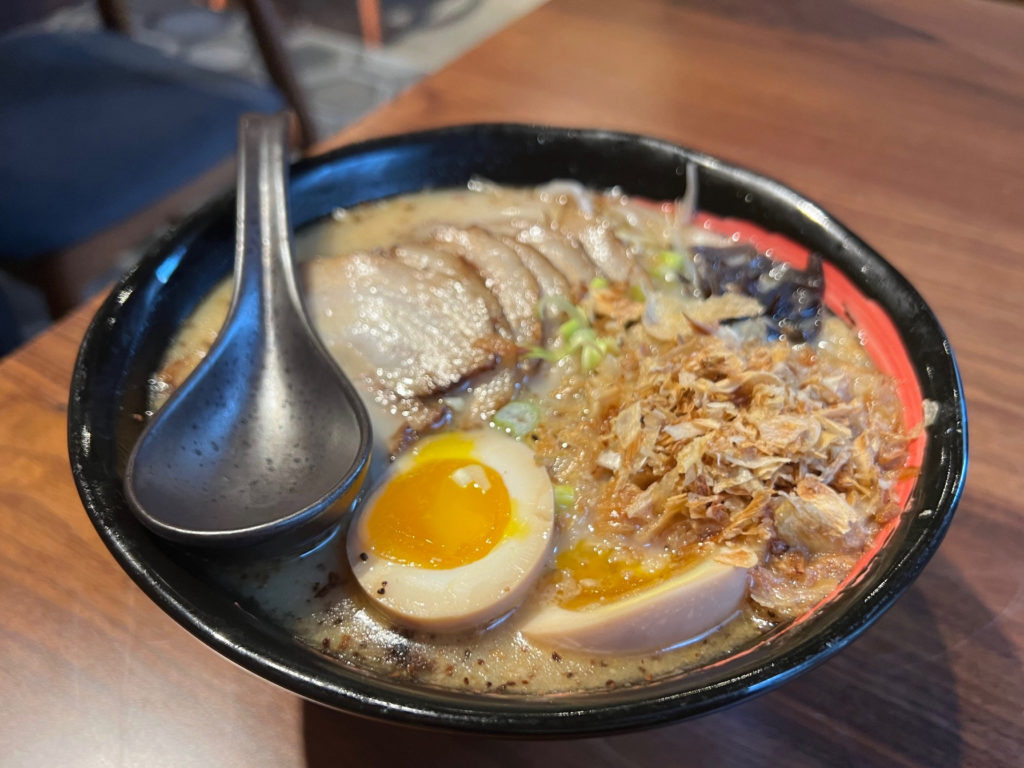 The ramen with two half eggs, pork, and crunchy onions.