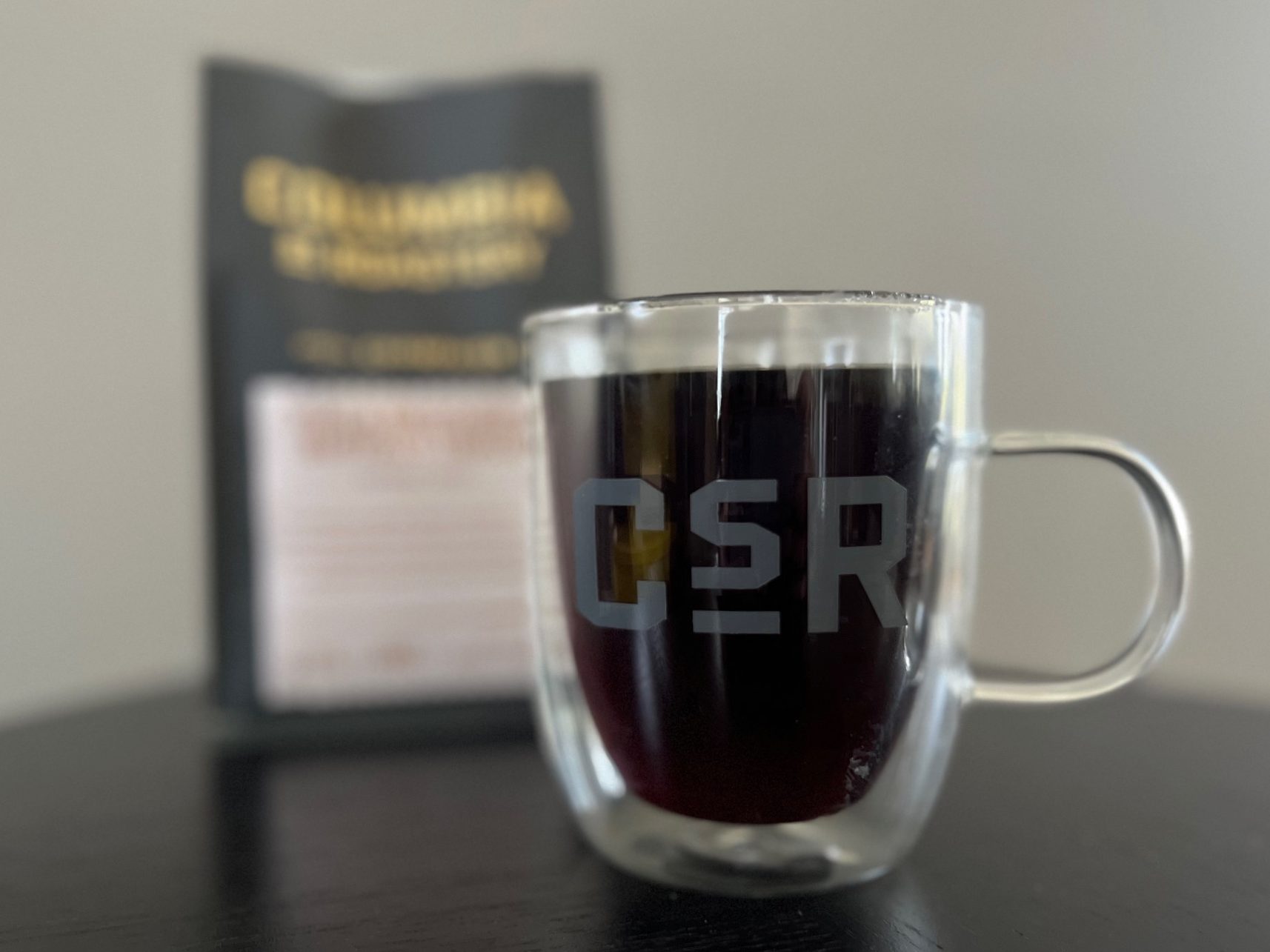 A cup that says CSR with coffee in it.