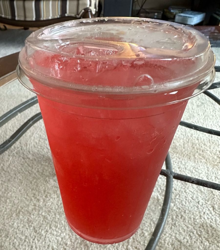 A red drink in a plastic cup at the author's home.